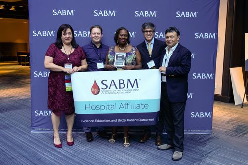 Representatives from SABM awarding a hospital affiliate certification to representatives from NYU Langone Medical Center